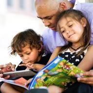 Dad and two kids reading